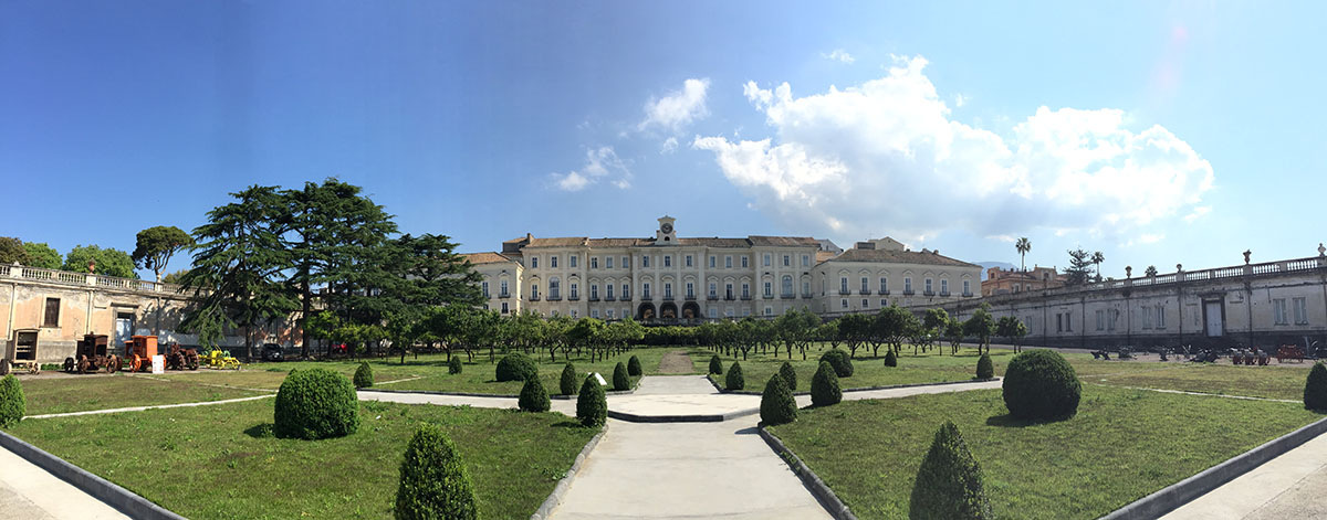 The majestic Royal Palace of Portici, an oasis of beauty among its vast gardens, with sea view